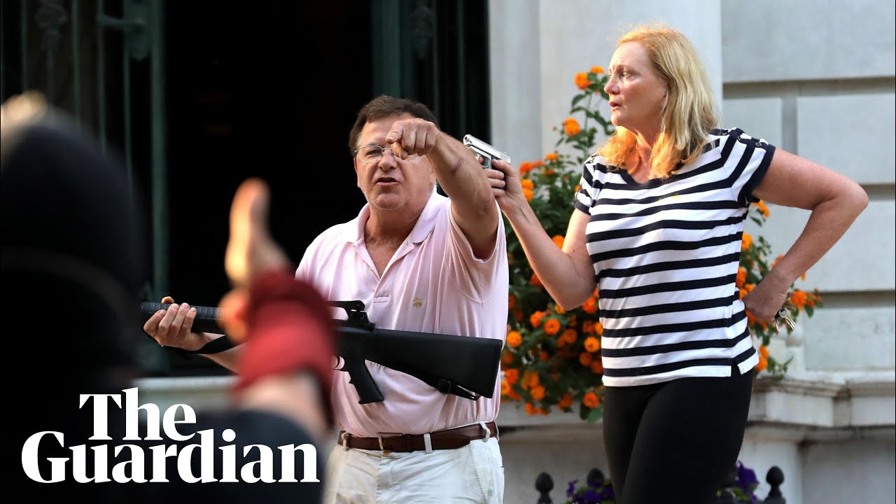 White couple point guns at protesters marching for police reform in Missouri